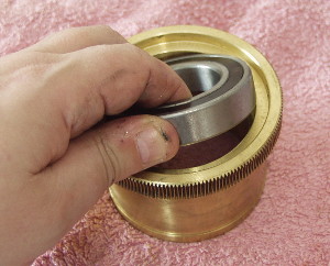 Remove the two roller bearings from the Declination gear. These may simply slide out or they may need to be tapped out using a wooden pole and a mallet as a driver. On this mount the bearing simply pushed free without much effort.